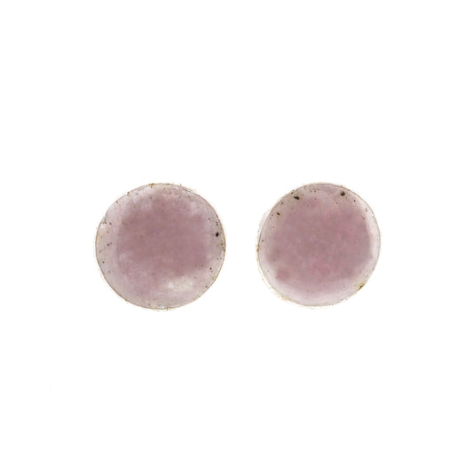 A pair of round silver stud earrings with a pale pink enamel finish.