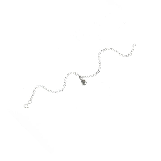 A silver chain bracelet with an organic style round charm engraved with a small heart.