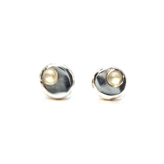 Round silver pebble stud earrings with mother of pearl gemstones flush set off-centre.