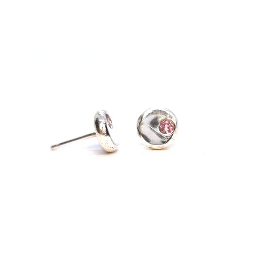 Round silver pebble stud earrings with pink tourmaline gemstones flush set off-centre.