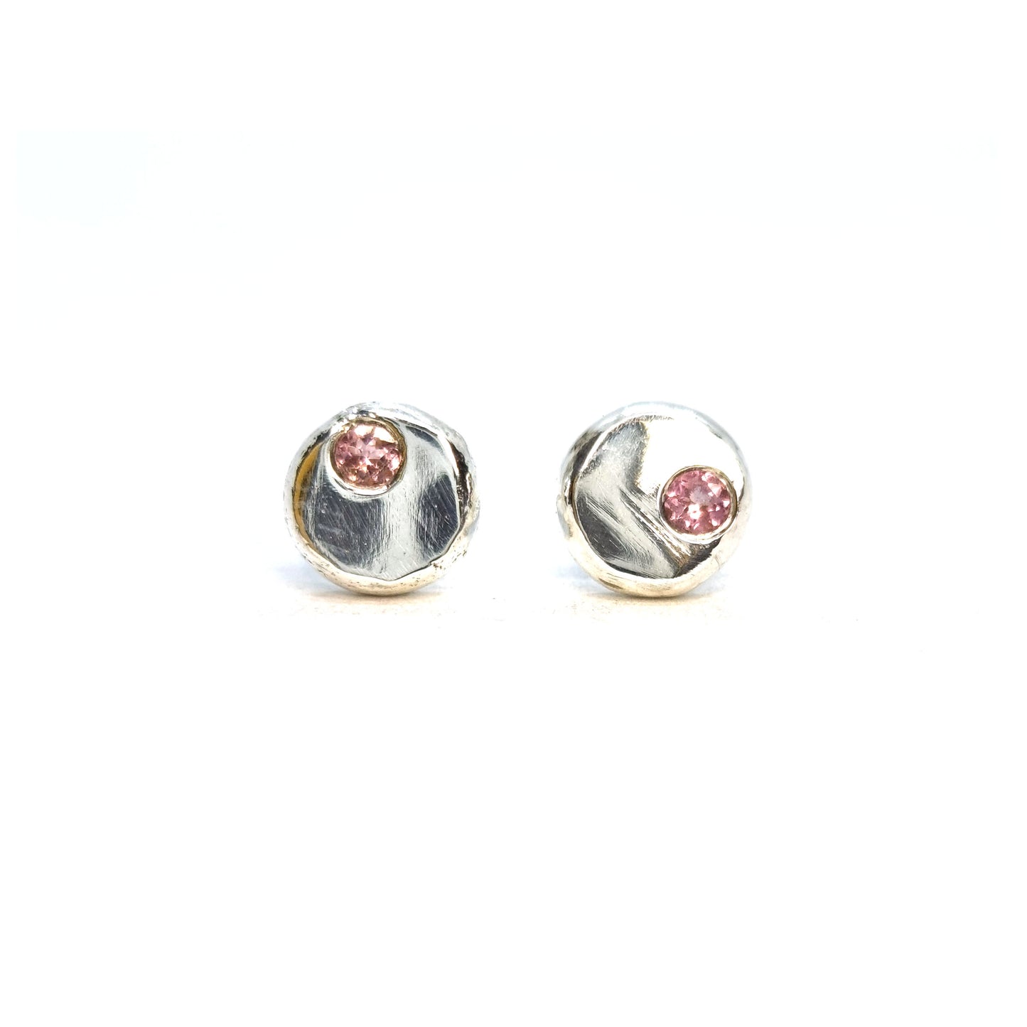 Round silver pebble stud earrings with pink tourmaline gemstones flush set off-centre.