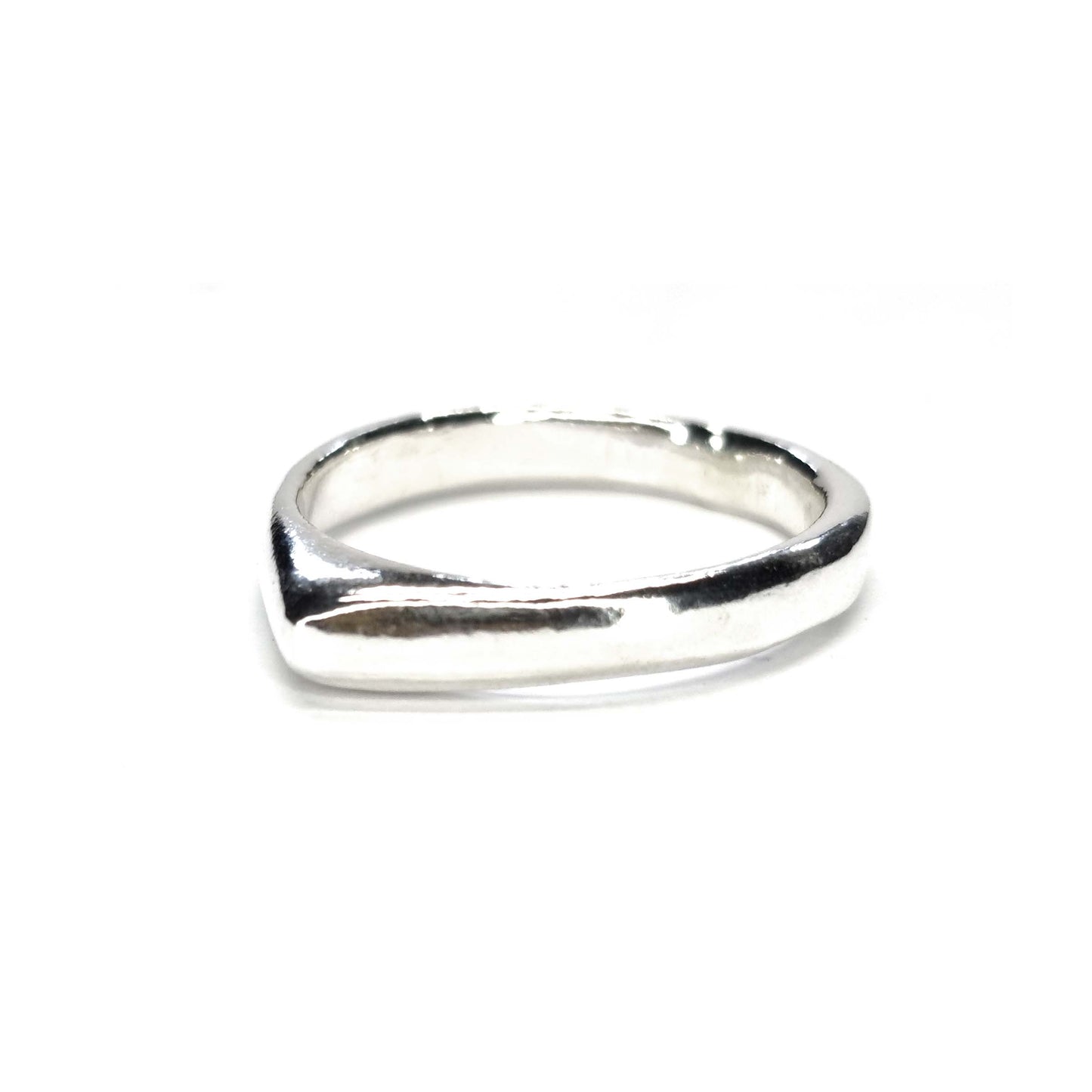 A silver ring which comes to a soft point at the top.
