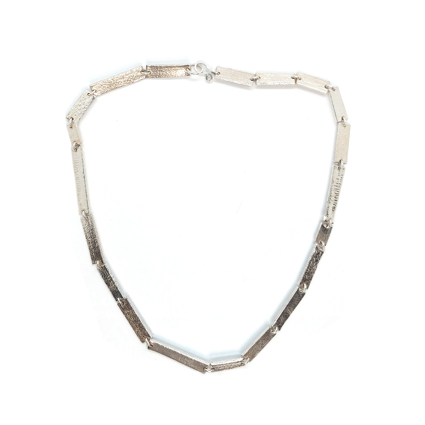 Silver necklace with textured rectangular links of different sizes.