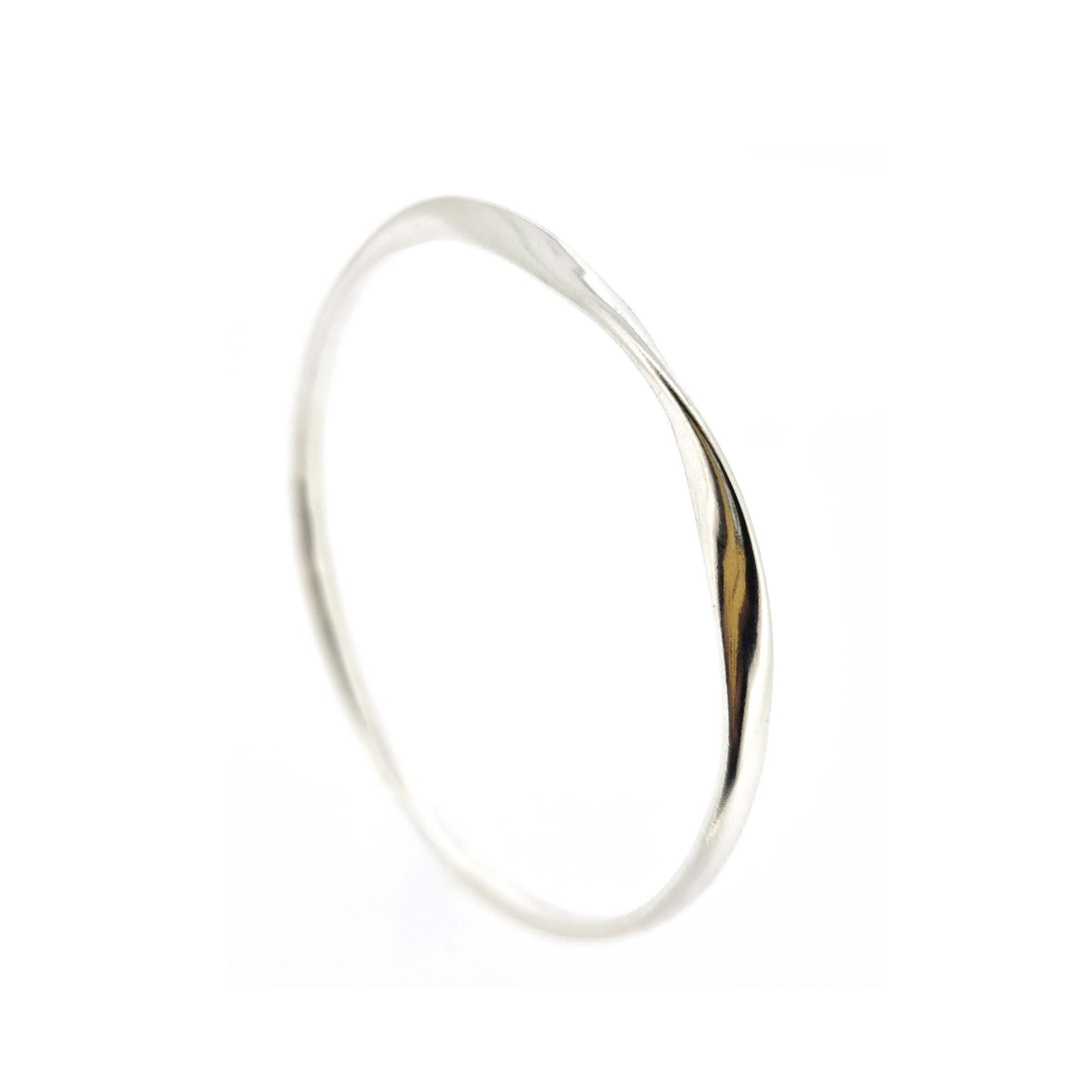 Round silver bangle with oval profile and a twist in one part.