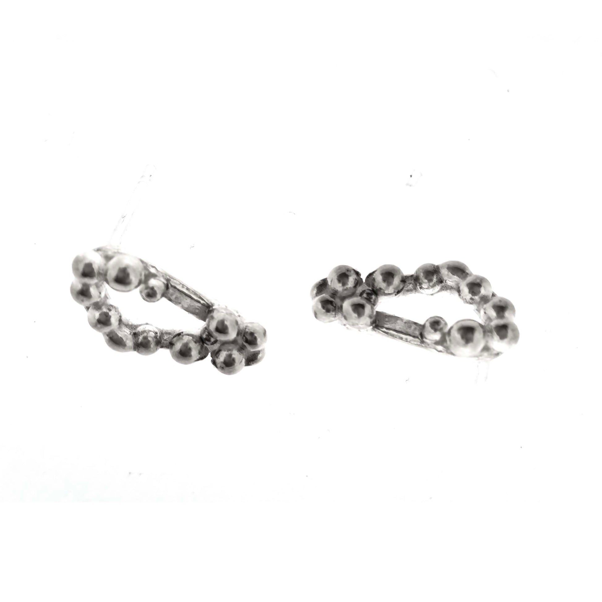 Silver stud earrings with an open soft triangle shape and silver balls.