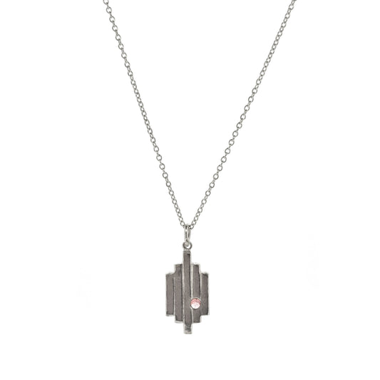 A silver Art Deco style pendant with 5 lines are a pink tourmaline gemstone set off center. On a silver chain.