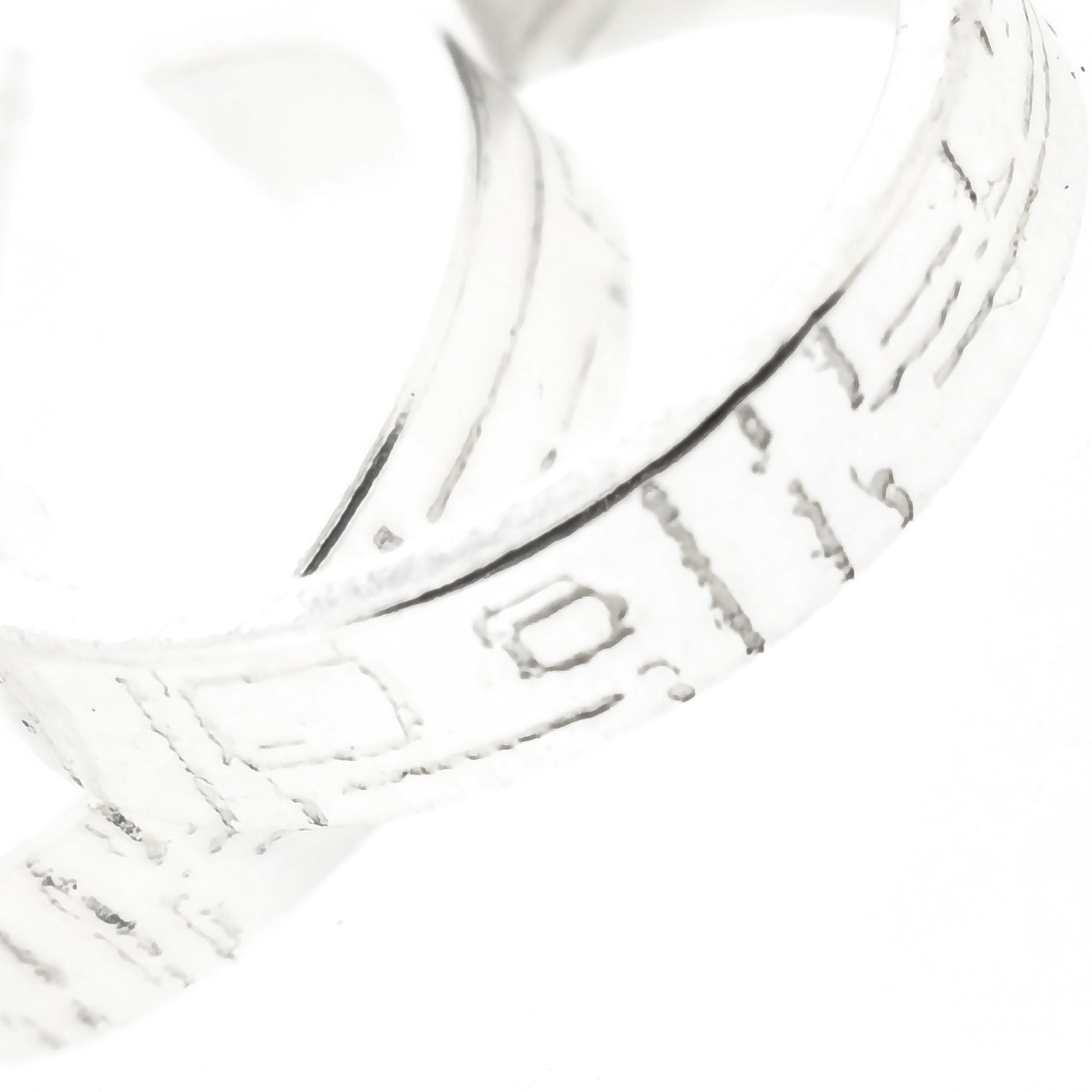 Close up of square line pattern on silver hoop earrings.