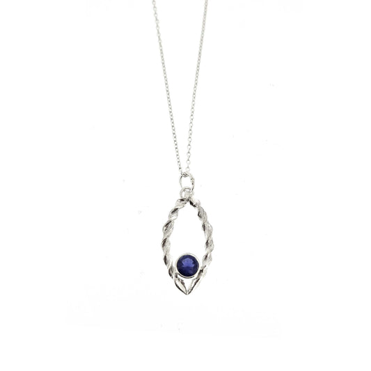 Silver pendant featuring 2 twists of silver making an open boat shape with a purple blue iolite gemstone set in the bottom point. On a silver chain.