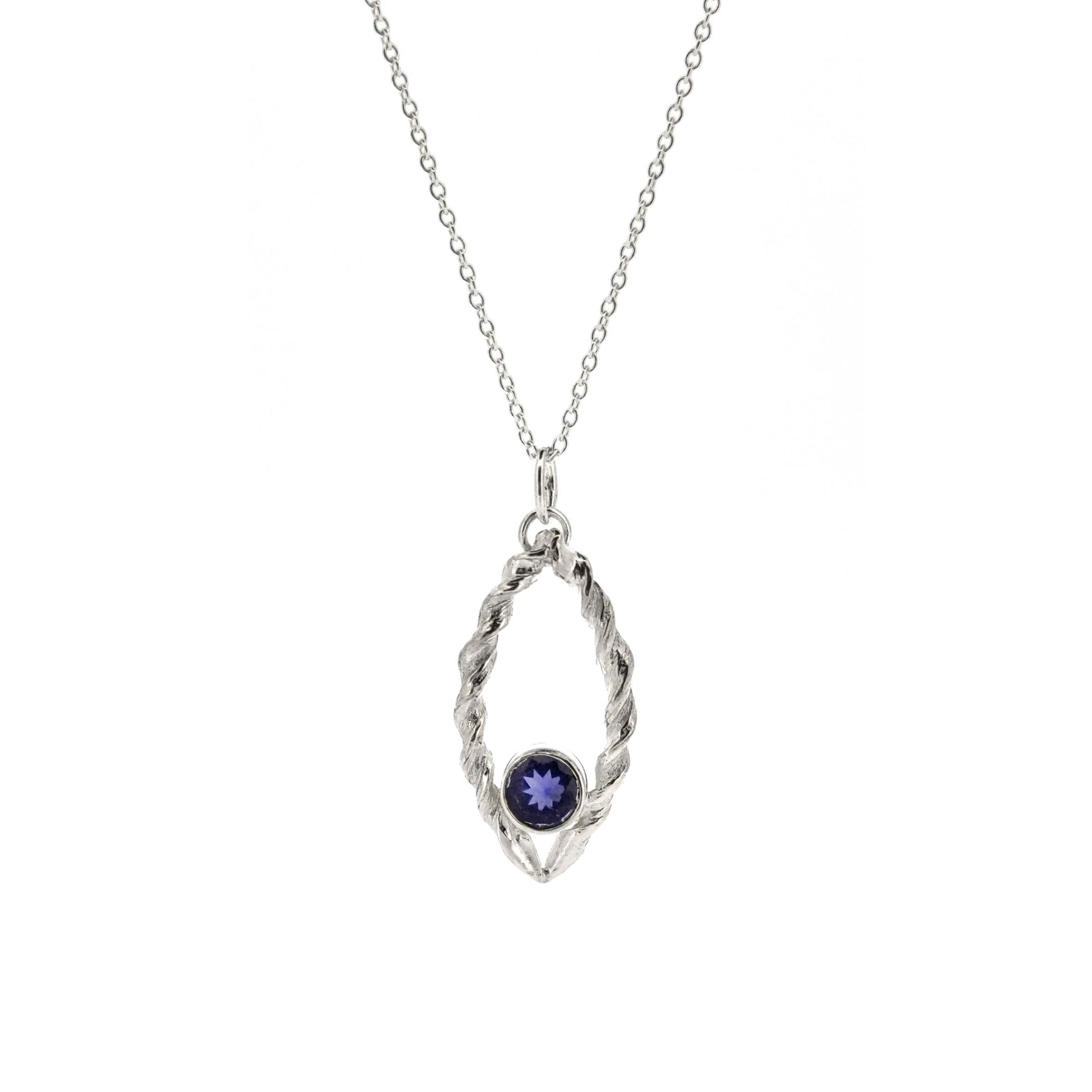 Silver pendant featuring 2 twists of silver making an open boat shape with a purple blue iolite gemstone set in the bottom point. On a silver chain.