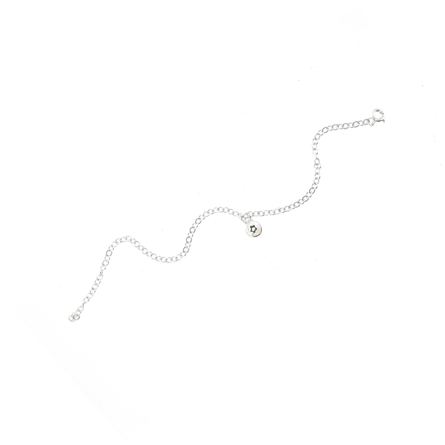 A silver chain bracelet with an organic style round charm with a star engraved on it.