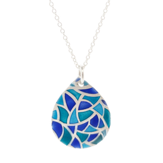 A teardrop shaped silver pendant with geometric cells of blue, green and turquoise enamel. On a silver chain.