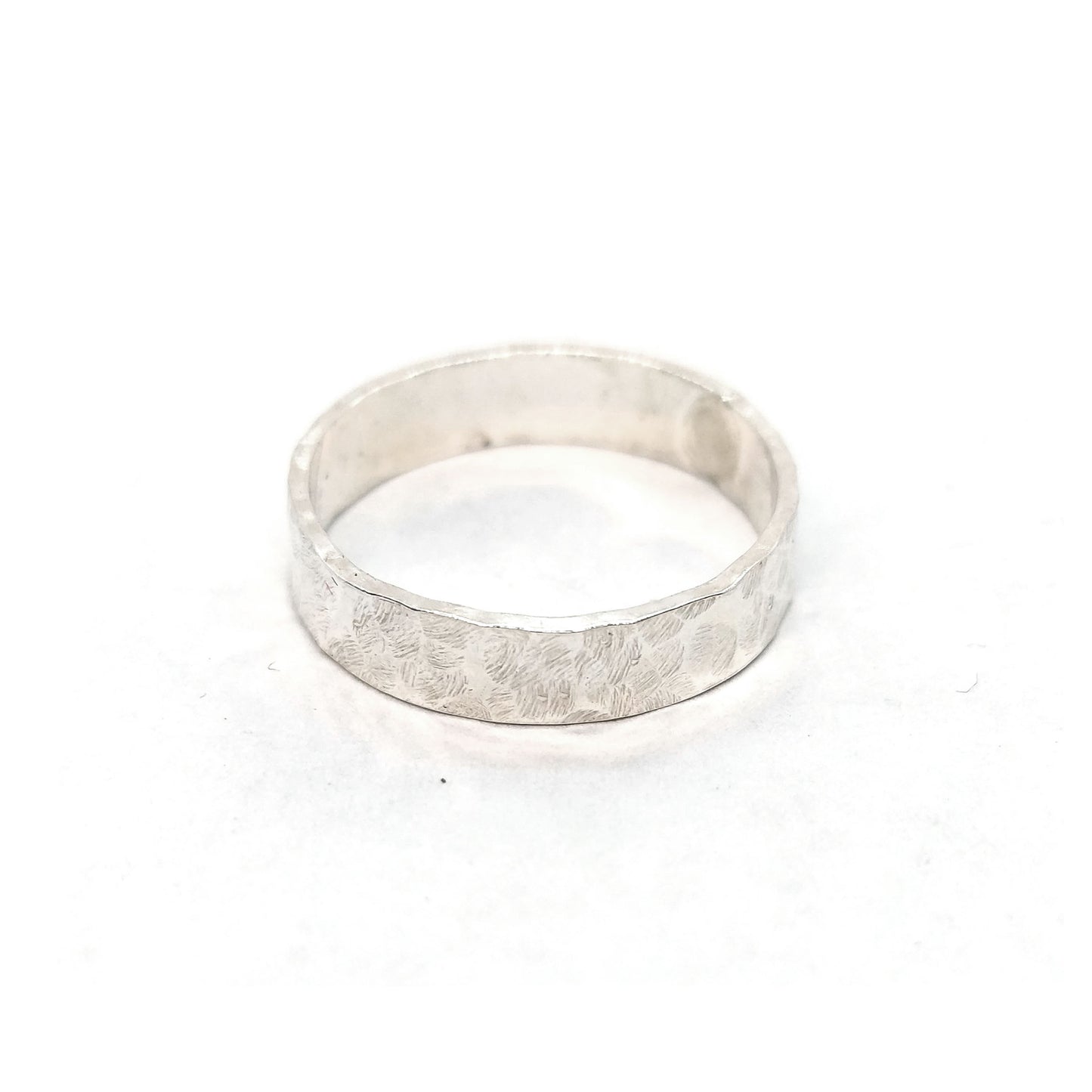 Silver hammered band ring with flat profile.