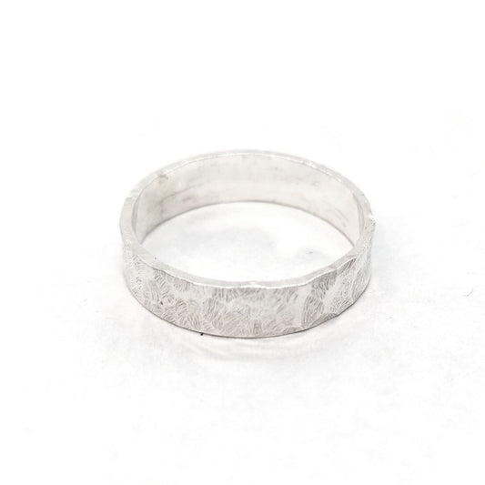 Silver hammered band ring with flat profile.