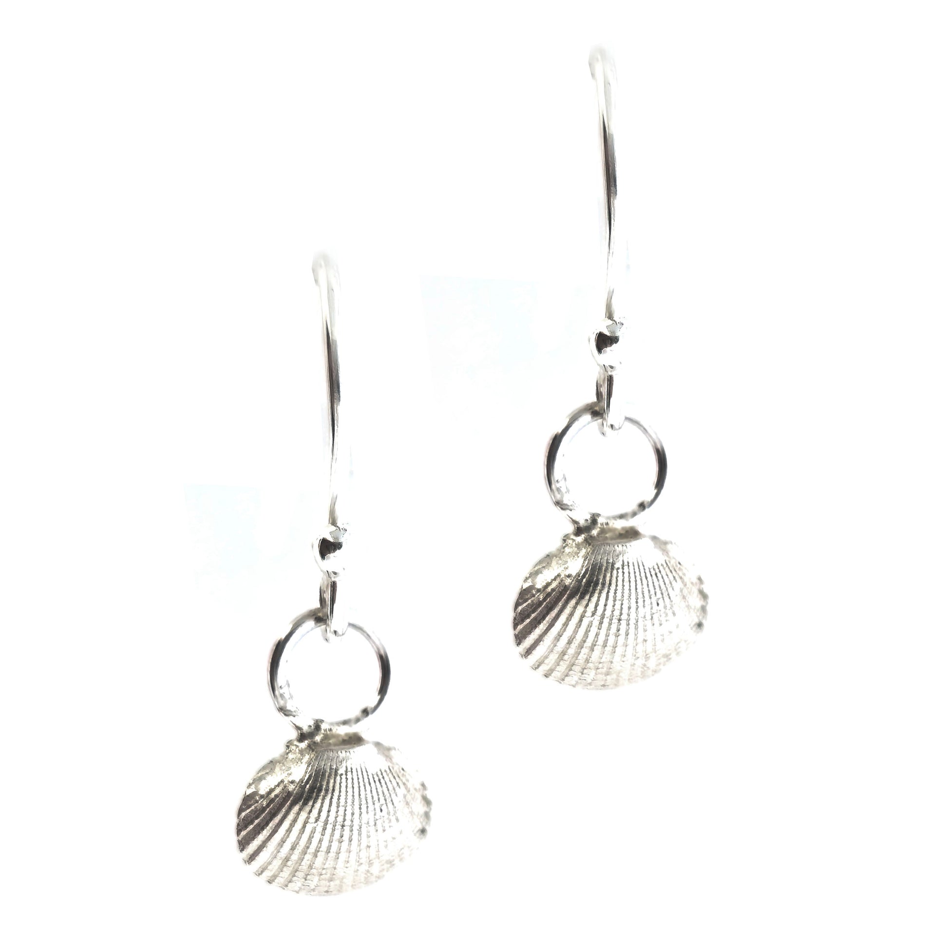 Silver cockle shell drop earrings on white background. Handmade. Mijoux Jewellery.