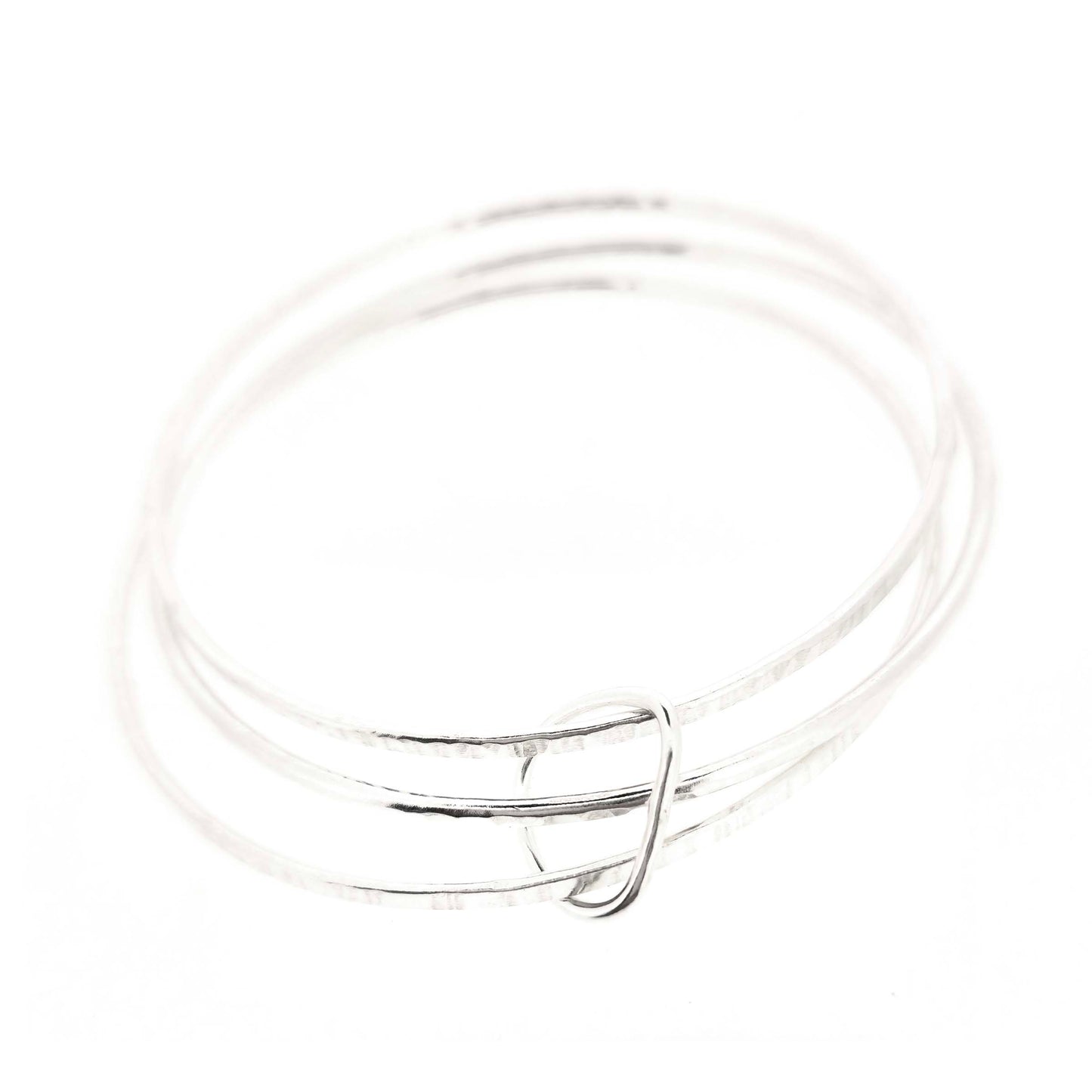 Triple textured silver bangle connected with soft edged open triangle charm.