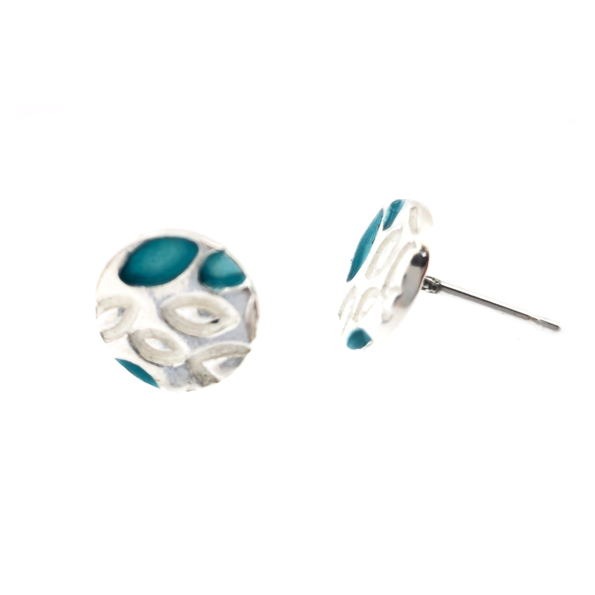 Round silver stud earrings with a leaf shape pattern. Some leaves are filled with turquoise enamel.