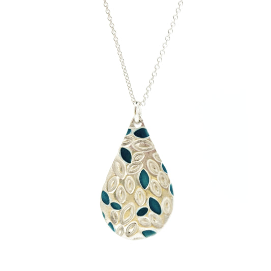 A silver teardrop shaped pendant with leaf shapes and turquoise enamel on a silver chain. Large.