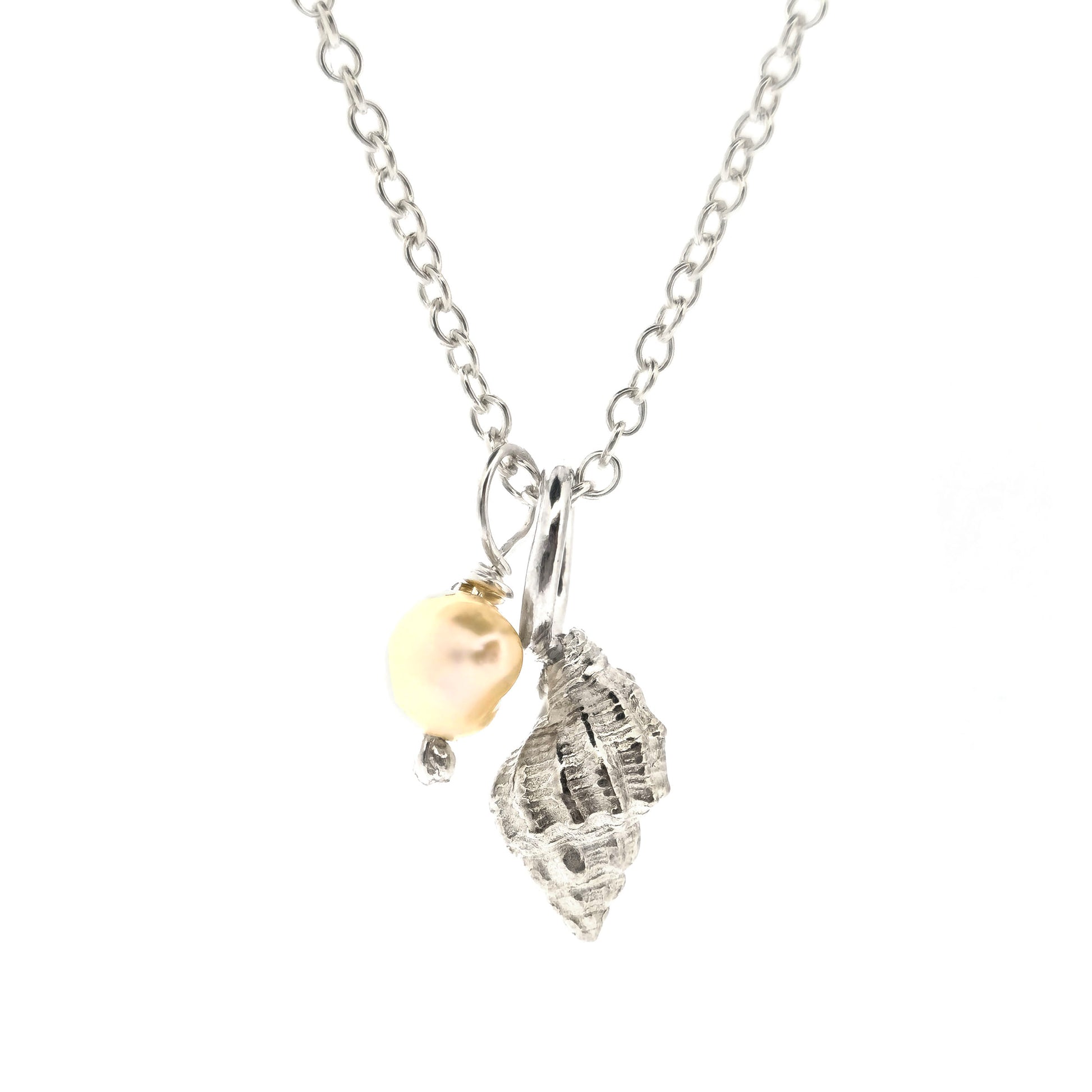 A silver periwinkle shell pendant with a cream coloured pearl suspended from a silver chain. On a white background. Handmade. Mijoux Jewellery.