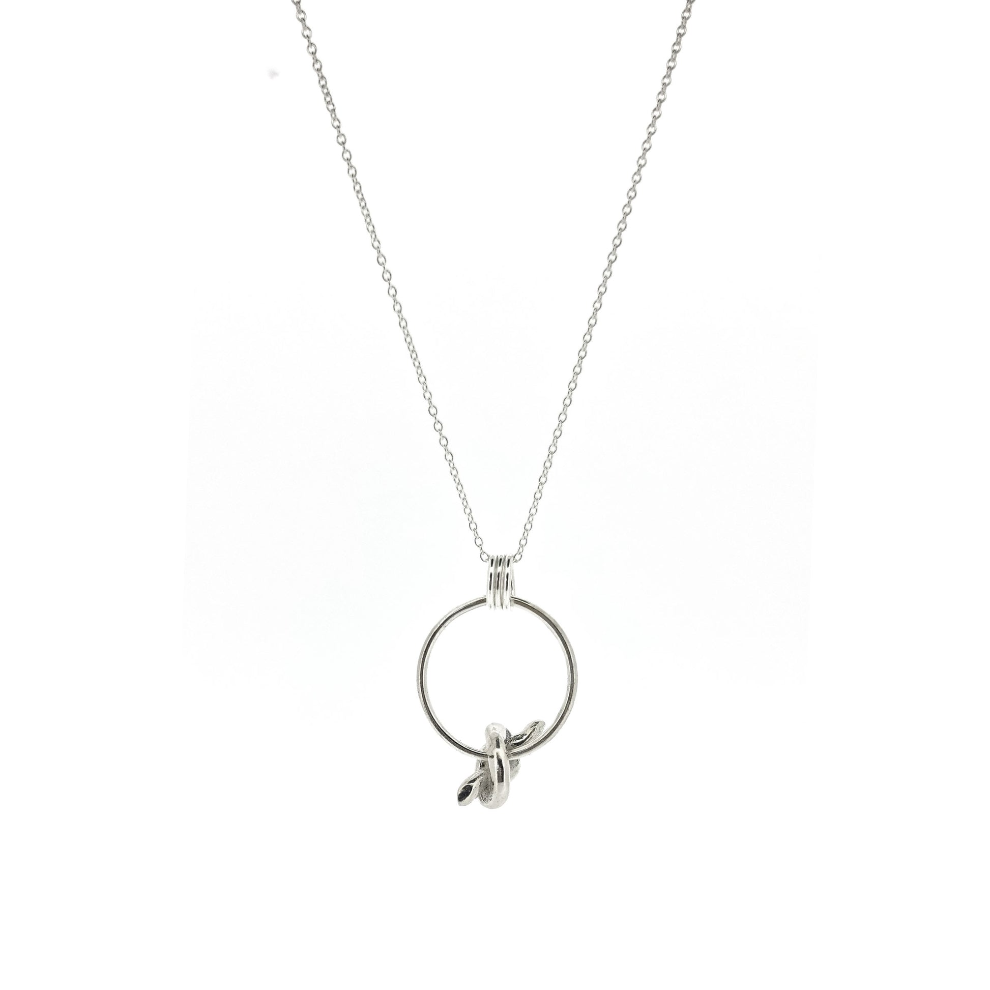 Silver circle pendant with spinning knot charm and triple circle bail. Suspended on a silver chain.