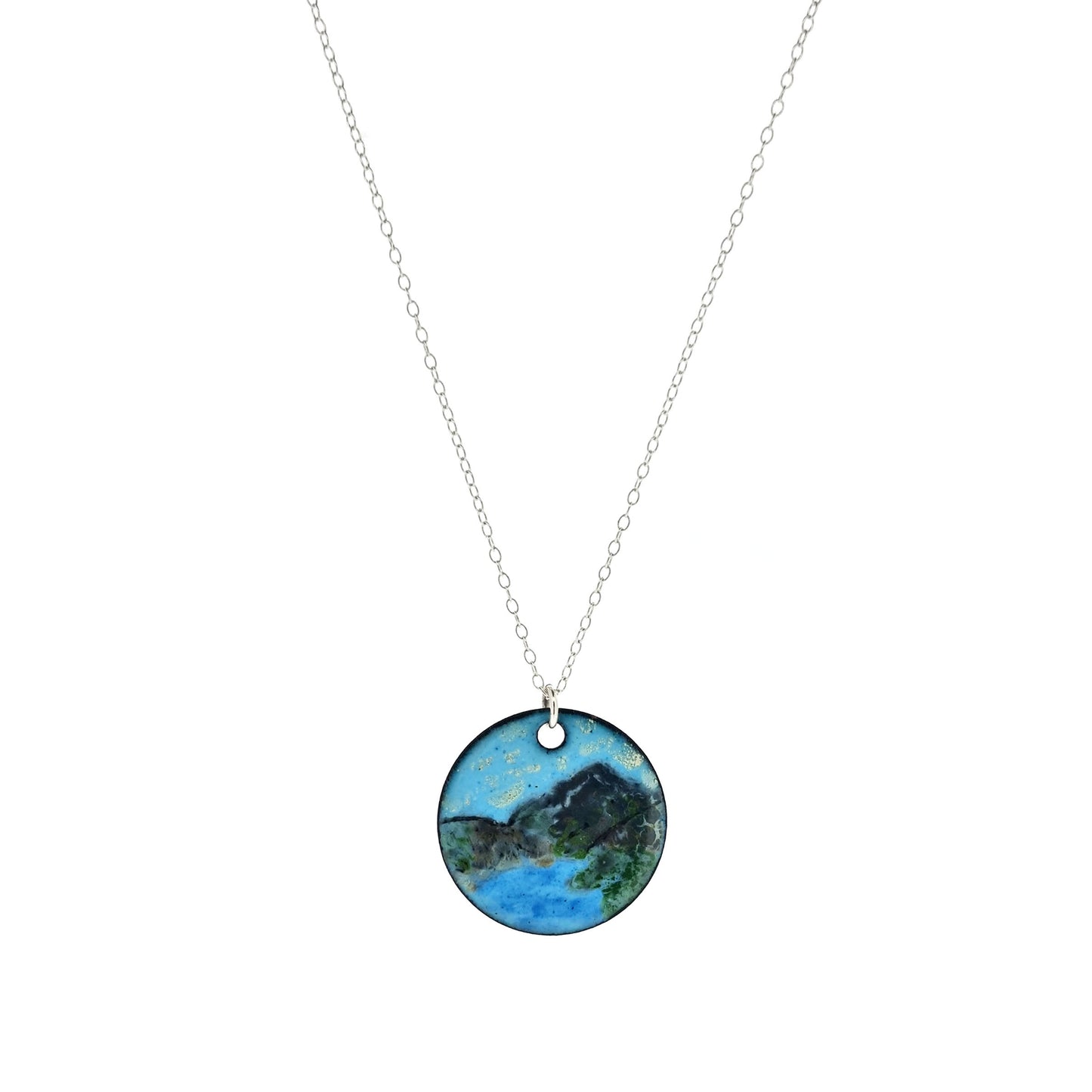 Round enamel pendant on silver chain. The pendant shows a landscape scene with a mountain and lake.