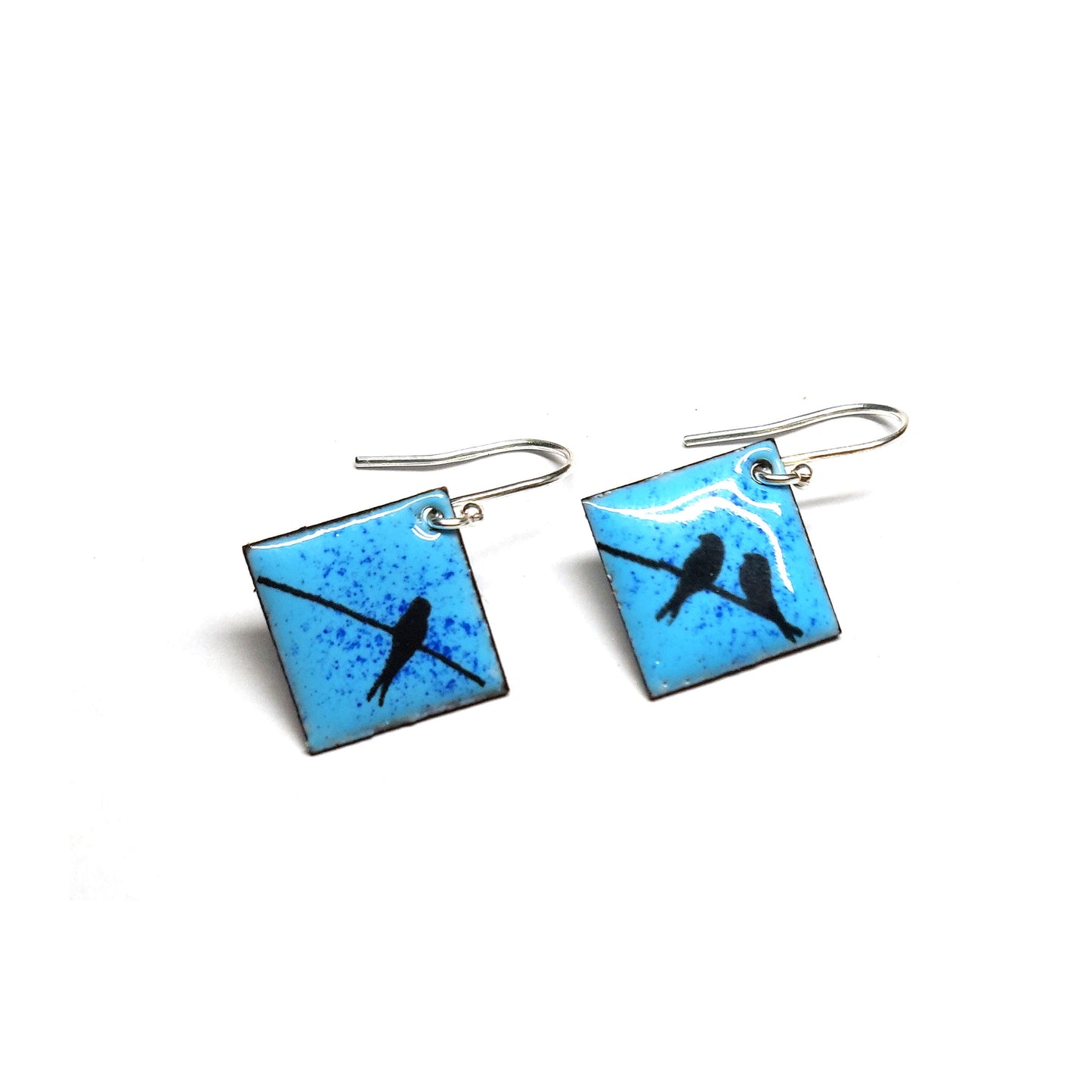 Square drop earrings featuring silhouettes of birds sitting on a wire against a blue enamel background.