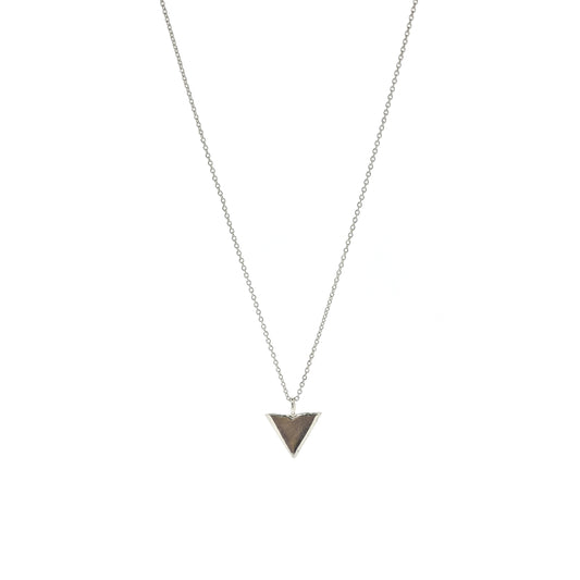 A silver beveled triangle shaped pendant on a silver chain