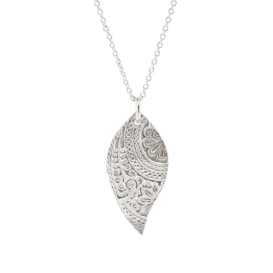 A silver asymmetric patterned leaf-shaped pendant on a chain