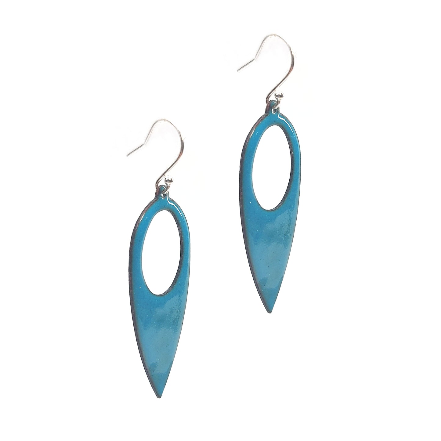 Teardrop shaped drop earrings with a circle cut our covered in teal enamel. On silver ear hooks.