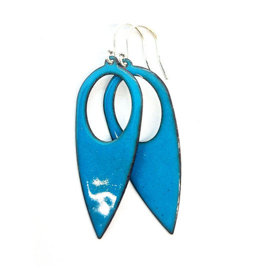 Teardrop shaped drop earrings with a circle cut our covered in teal enamel. On silver ear hooks.