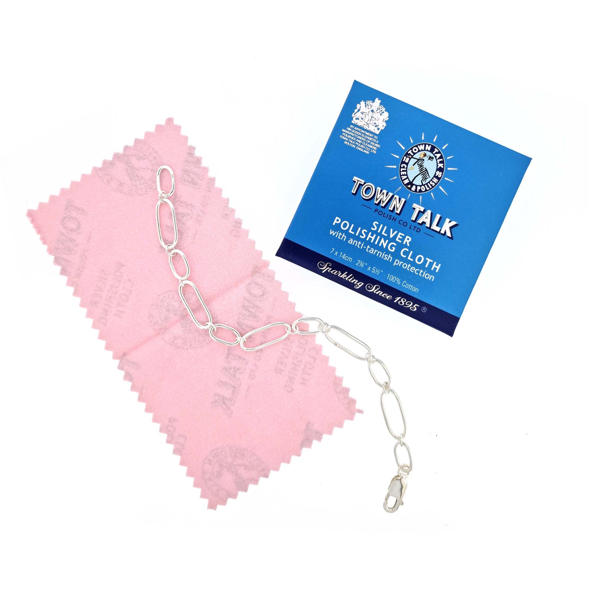 A pink coloured silver polishing cloth by Town Talk pictured with a silver bracelet.