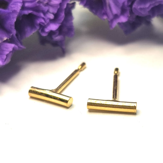 Yellow gold vermeil rounded bar stud earrings. Pictured with flowers.