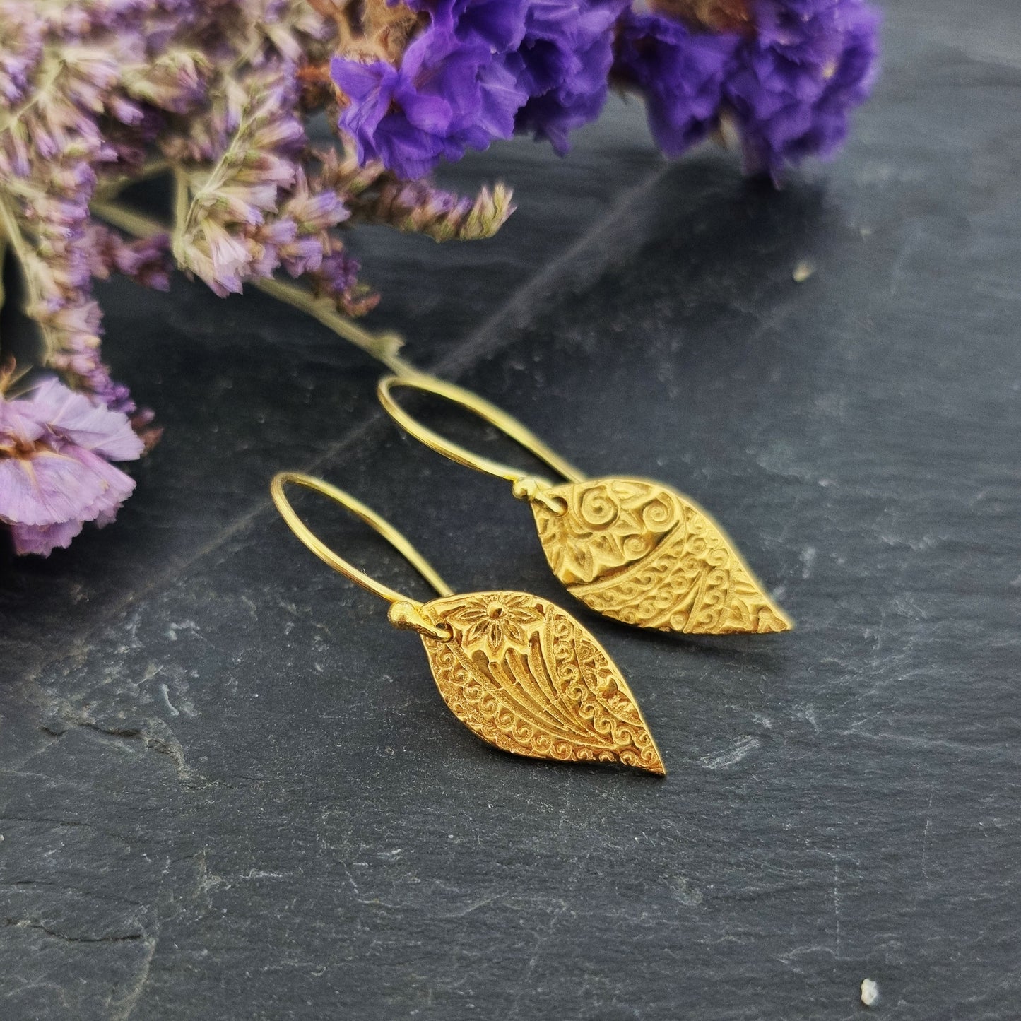 Yellow gold vermeil leaf-shaped patterned drop earrings.