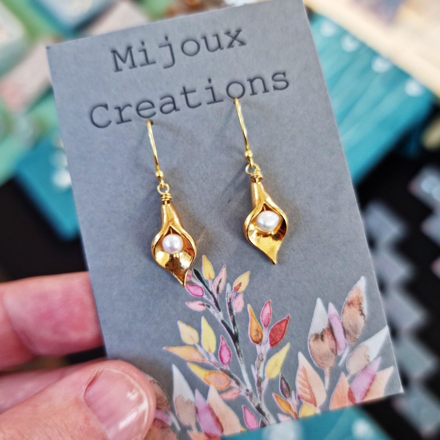 Yellow gold vermeil cala lily drop earrings with freshwater pearls. Pictured on Mijoux Creations card.