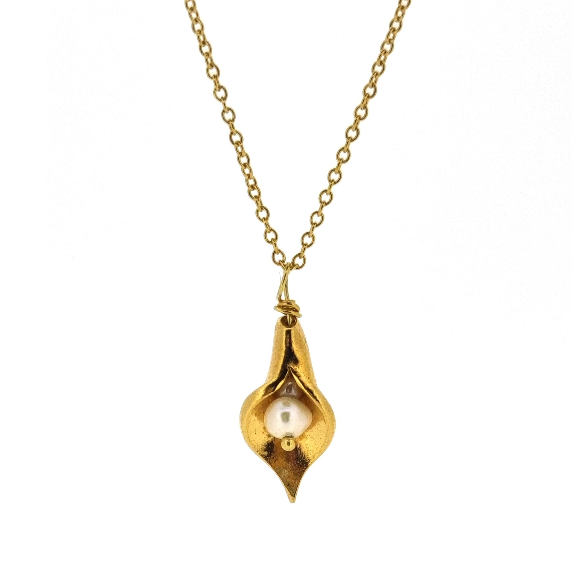 A yellow gold vermeil calla lily pendant with a freshwater white pearl on a yellow gold vermeil chain.