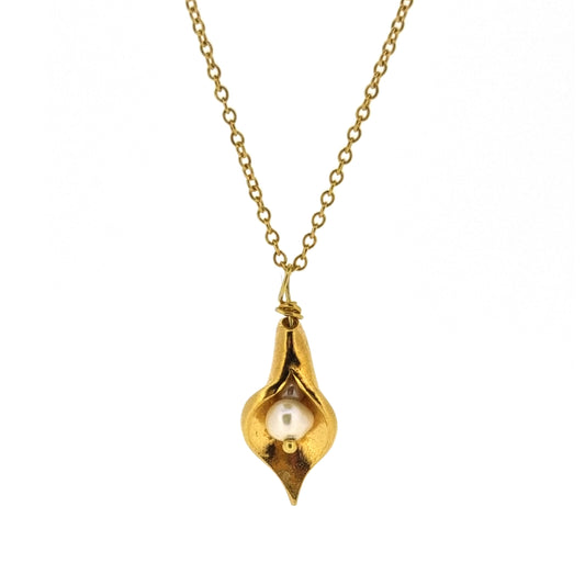 A yellow gold vermeil calla lily pendant with a freshwater white pearl on a yellow gold vermeil chain.