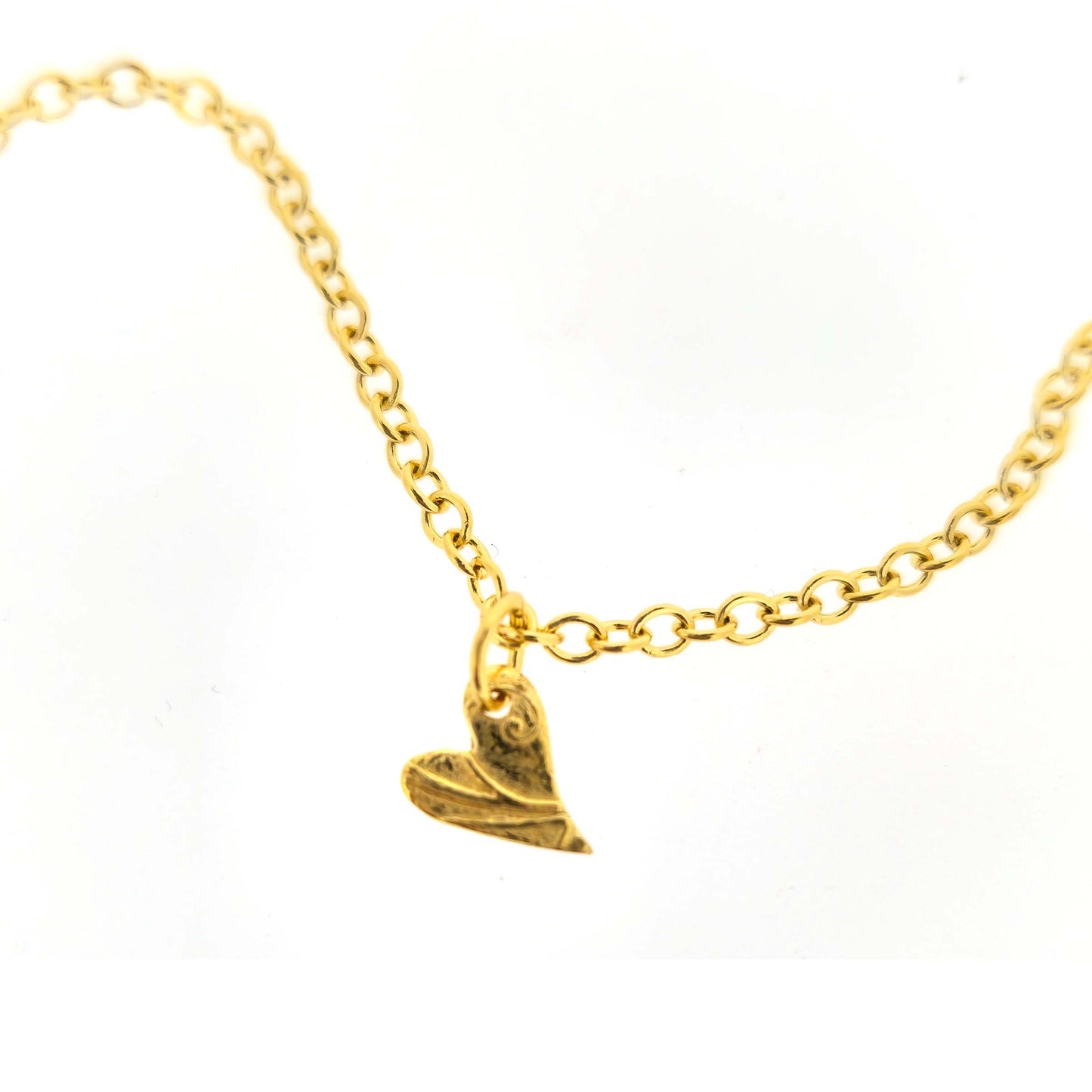 Gold bracelet with a textured asymmetric heart-shaped charm on a white background