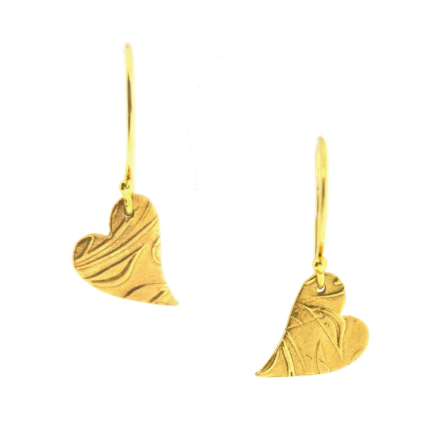 Yellow gold vermeil drop earrings featuring an asymmetrical heart with a leaf vine pattern suspended from an ear wire.