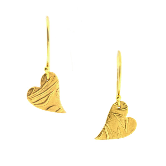 Yellow gold vermeil drop earrings featuring an asymmetrical heart with a leaf vine pattern suspended from an ear wire.