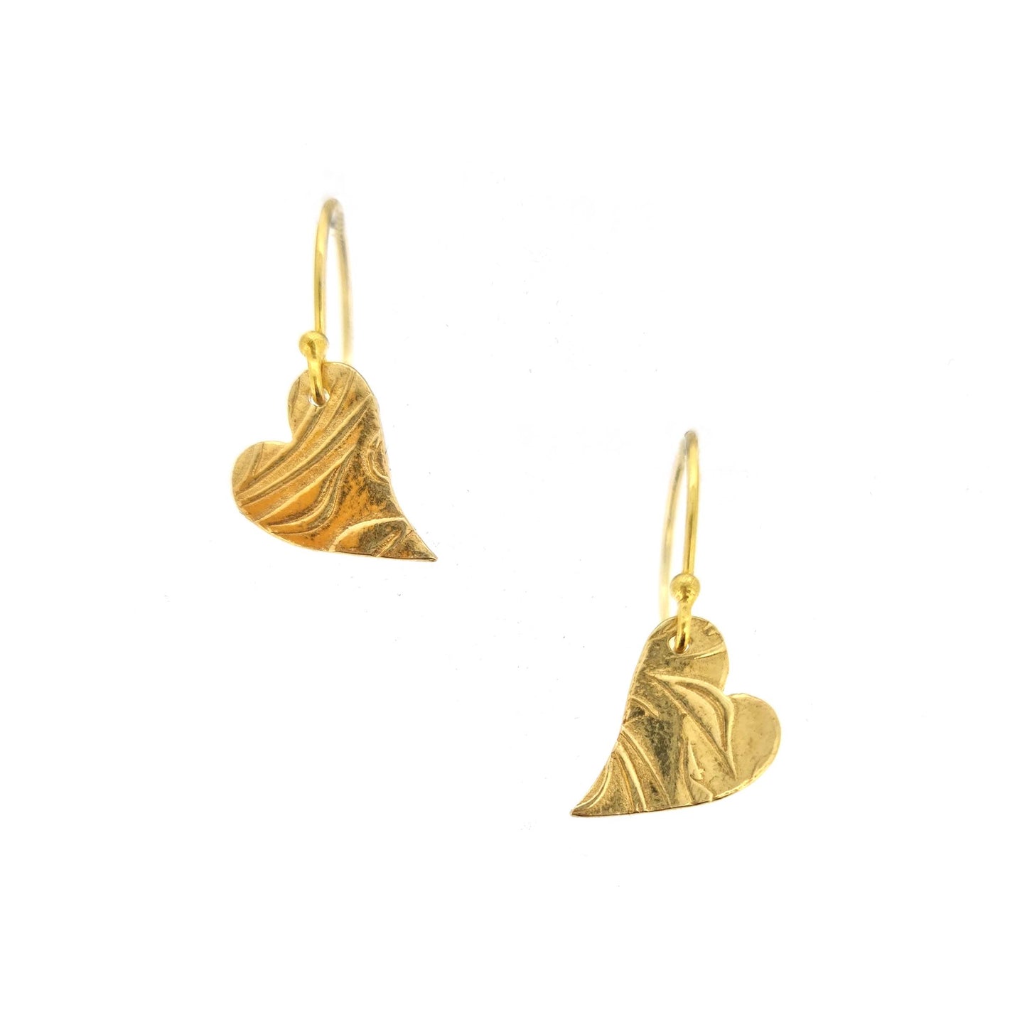 Yellow gold vermeil drop earrings featuring an asymmetrical heart with a leaf vine pattern suspended from an ear wire.