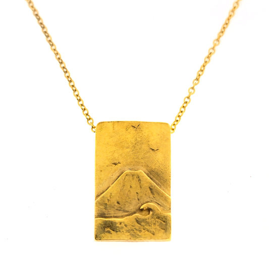 A rectangular yellow gold vermeil pendant featuring a mountain and sea scene. The pendant has an invisible bail and is on a yellow gold vermeil chain.