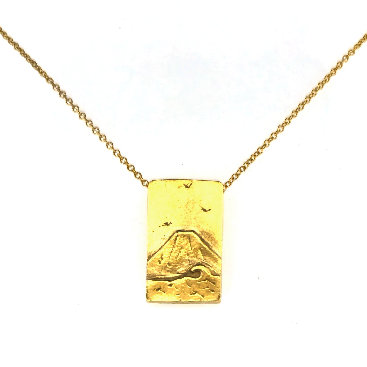 A rectangular yellow gold vermeil pendant featuring a mountain and sea scene. The pendant has an invisible bail and is on a yellow gold vermeil chain.